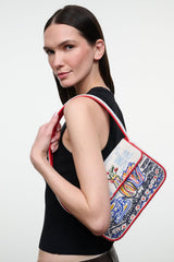 Beaded mini bag with red handle and beadwork design, side carry on model