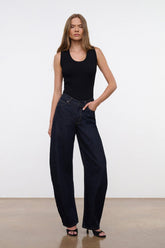 Indigo barrel-leg jeans worn by model, full outfit view
