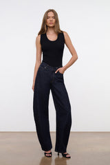 Indigo barrel-leg jeans worn by model, full outfit view