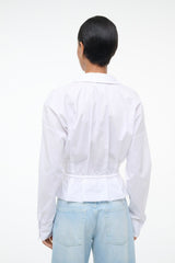 Back view of white button-up shirt with cinched waist and long sleeves