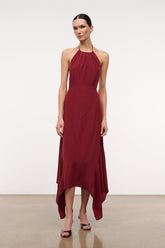 Silk halter dress in dark red with draped asymmetrical hem