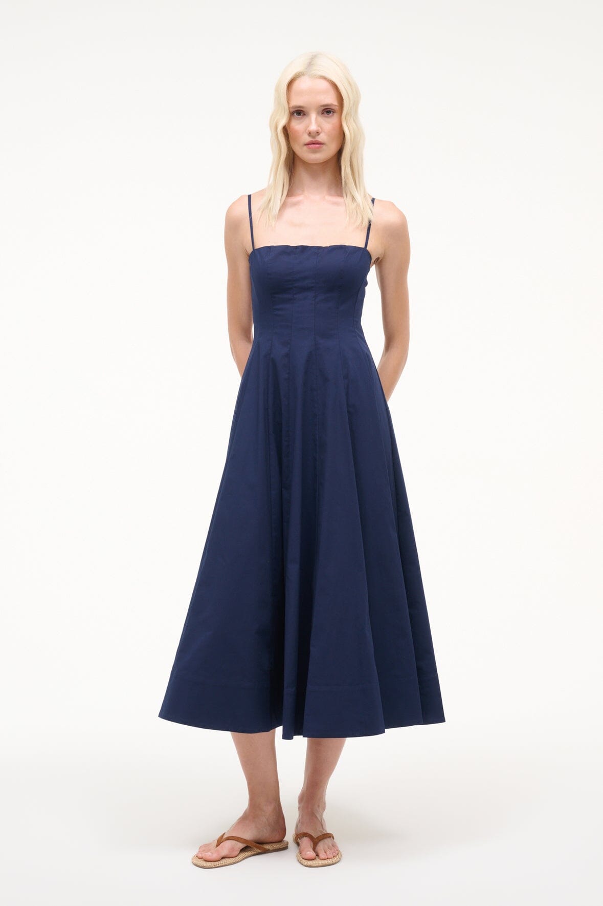 Navy sleeveless dress with spaghetti straps and gathered midi skirt