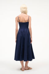 Back view of navy sleeveless dress with spaghetti straps and gathered skirt