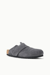 A single gray suede clog shoe with a black sole and a small tan cork heel insert, shown from a side profile on a clean white background.