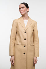 Women's tan leather coat with notch lapel, center buttons, and side pockets