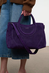Amethyst purple suede tote satchel with rounded handles and long crossbody strap