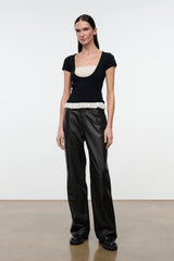 Black knit top with scoop neckline and ivory ruffled hem