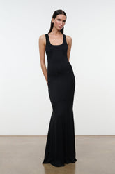 Black sleeveless maxi dress with scoop neck and thin straps, fitted body to long hem