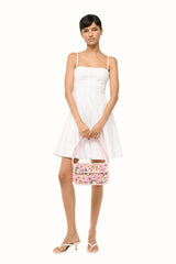 White mini dress with thin straps, sweetheart neckline, gathered flared hem