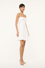 White mini dress with spaghetti straps and flared skirt, side profile