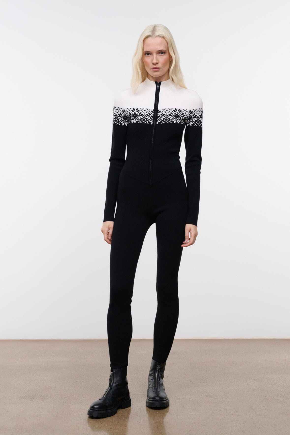 Black snowboard onesie with white patterned yoke and zip-front, long sleeves