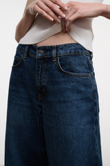 Dark-wash denim jeans with button-and-zip fly, belt loops, and front yoke