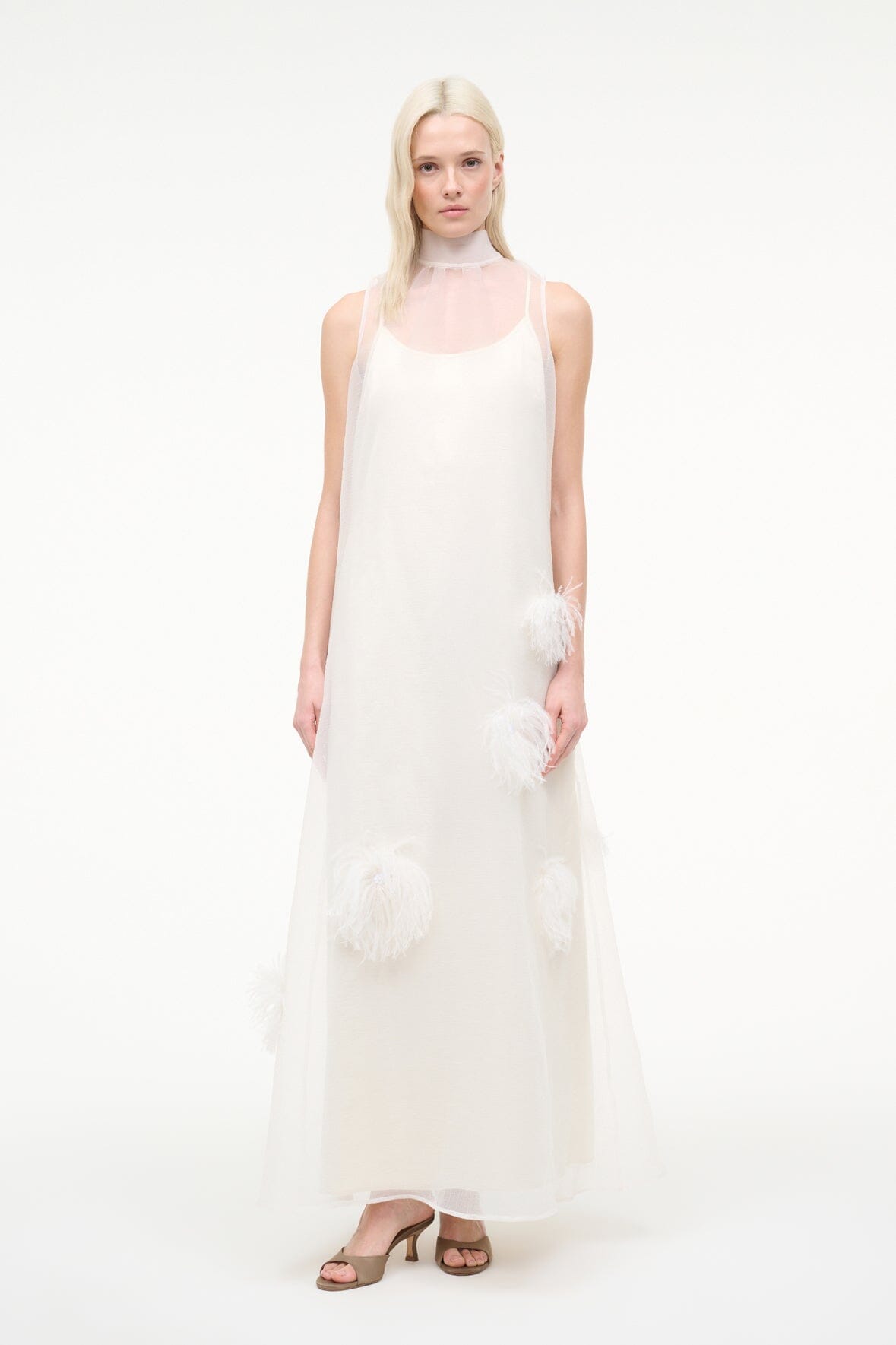 White sleeveless maxi dress with feather trim accents and flowy layered skirt