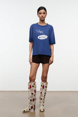 Tall suede patchwork boots on model, cream with red and brown heart motifs and low heel