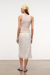 Ivory ribbed racerback tank top, back view with small hem detail