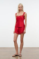 Tomato red silk short set with lace trim, worn by model