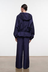 Hooded dark navy jacket with elastic cuffs and adjustable hem, back view