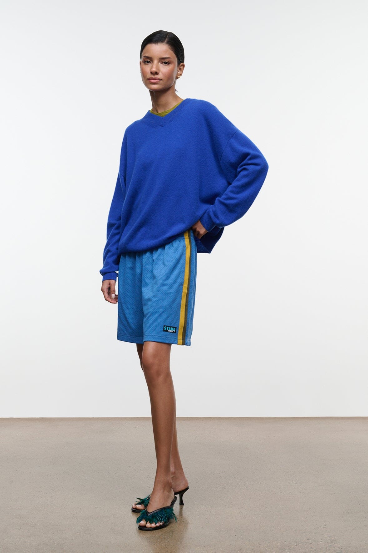 Haskell blue shorts with elastic waist and yellow side stripe; side logo patch.