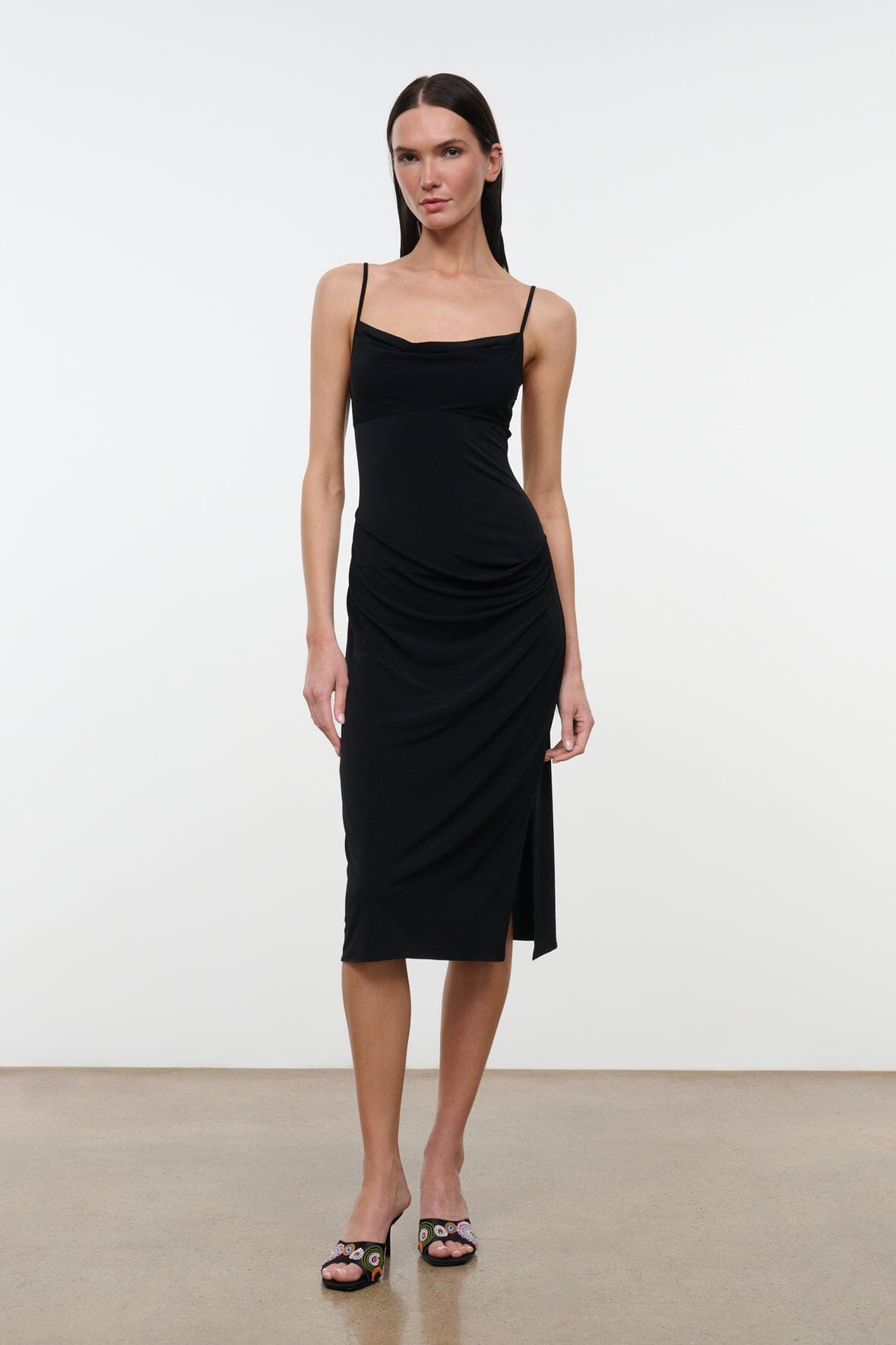 Black draped midi dress with spaghetti straps and cowl neckline