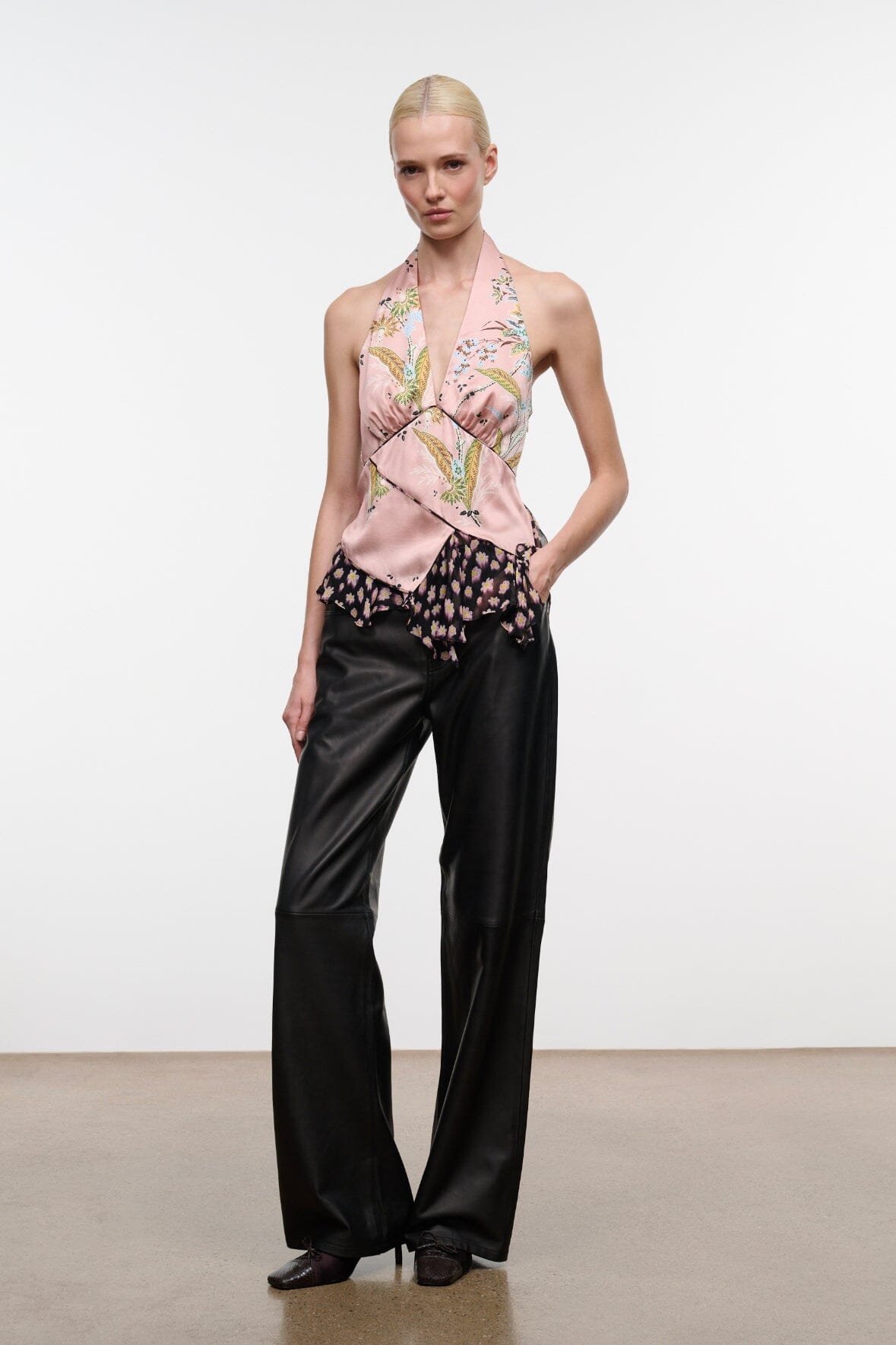 Pink silk halter top with multi-color print, draped neckline and ruffled hem