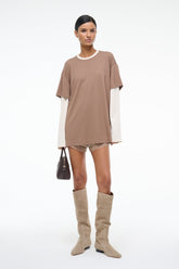 Taupe short-sleeve tee with lace-trim hem and white long-sleeve underlayer, full-length view