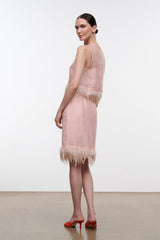 Light pink satin midi skirt with feather fringe hem, side view