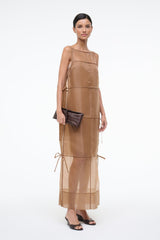 Brown croc-textured leather clutch, held at side with adjustable strap