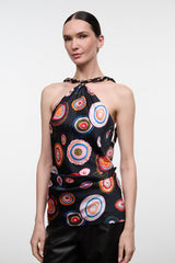 Silk halter top with multicolor circular print on black, sleeveless keyhole
