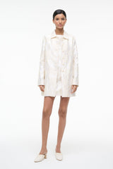 Ivory long-sleeve button-front mini dress with textured leaf print, front view.