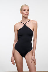 Black one-piece swimsuit with halter neckline and crossed back straps