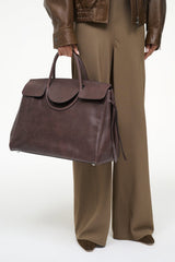 Large Maude carryall bag in espresso brown, top handles and front flap with tassel tie