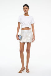 White sequin mini skirt with vertical sparkle texture and fringe hem