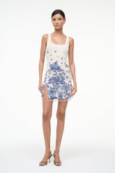 Full view of sleeveless blue toile shift dress with thin straps, square neck, tassel fringe hem