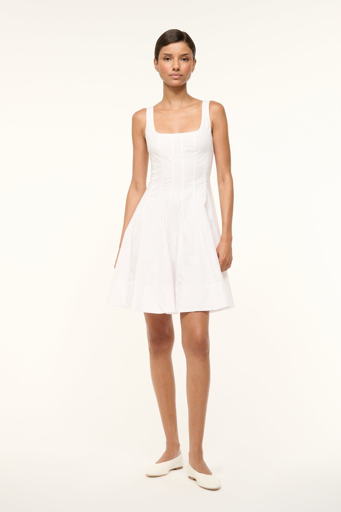 White sleeveless mini dress with fitted bodice and flared skirt
