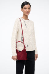 Burgundy suede shoulder bag with shoulder strap and compact triangular shape