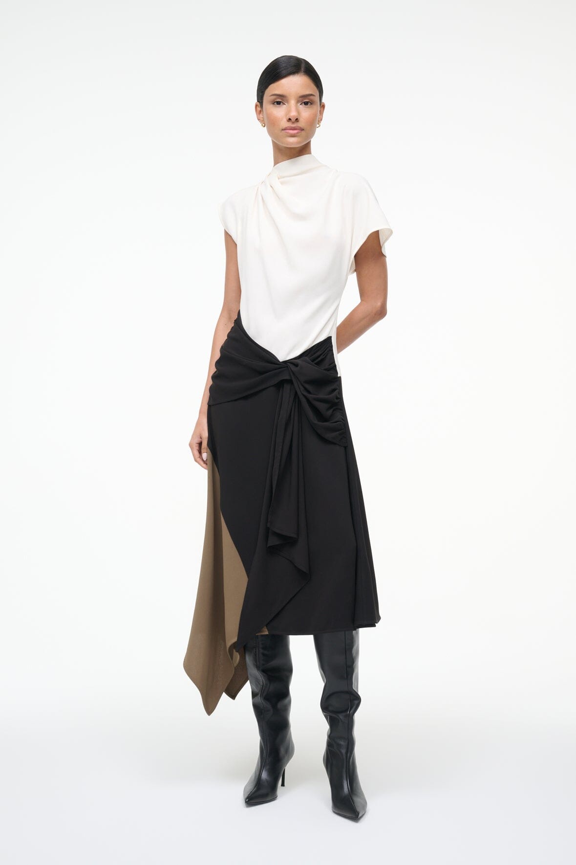 Sleeveless high-neck dress, front view, white top with black wrap knot and tan side panel