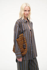 Drift shoulder bag in multi wood beads with black shoulder straps and side tassel accents