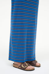 Raffia slide sandal with dark brown straps, tan footbed, and gold buckle at ankle
