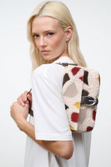 Patchwork suede crossbody bag with top handle and patterned front panel