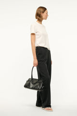 Black shoulder bag with curved handles and long side silhouette