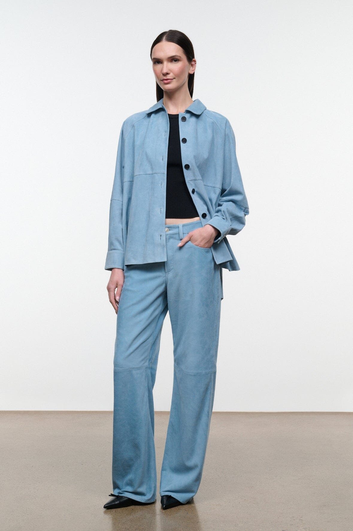 Sky-blue suede shirt with point collar and black buttons; relaxed fit, long sleeves