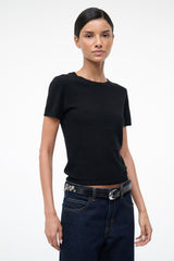 Black belt with silver moon buckle and studded rivet trim, worn at waist