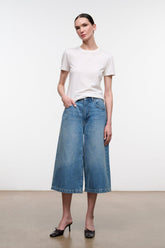 Light blue denim culotte jeans with straight wide-leg cut and center front seam