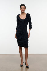 Black ruched midi dress with ruffled shoulders and long fitted sleeves.