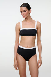High-rise bikini bottom with white trim, black, angled front view on model.