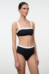 Black and white bikini top with square neckline, thin straps, and white underband