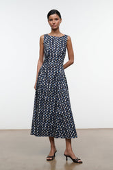 Sleeveless navy midi dress with abstract yellow-dot print, round neckline and pleated skirt
