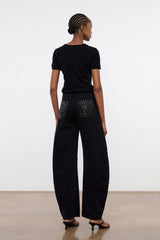 Black barrel jeans with studded back pockets, ankle-length