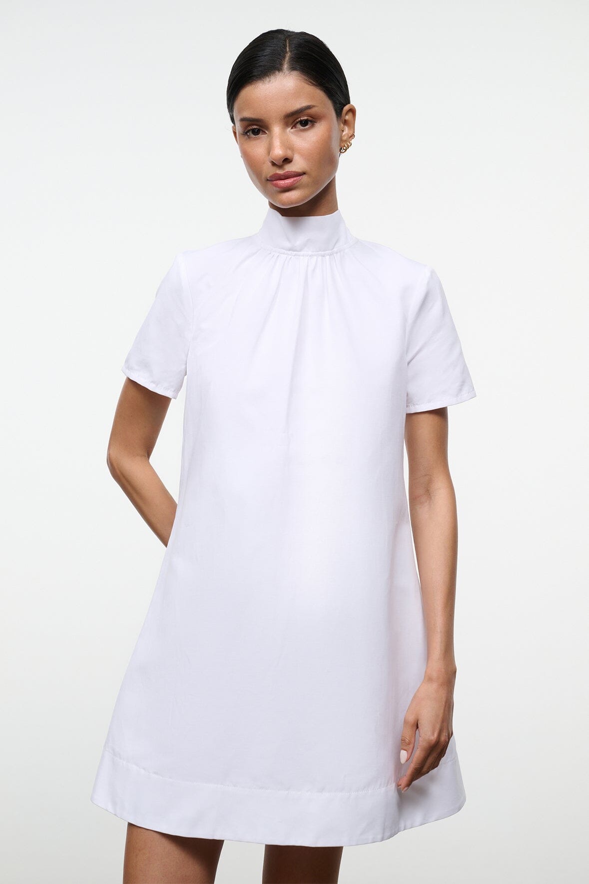 White mini dress with high neck and gathered pleat detail at the collar