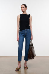Stone blue denim cropped jeans with raw hem and front pockets, side view